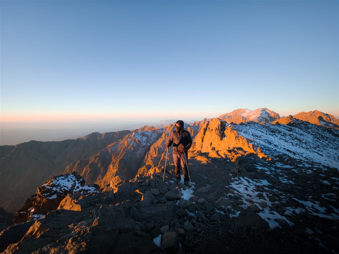 Adam on a summit at sunrise