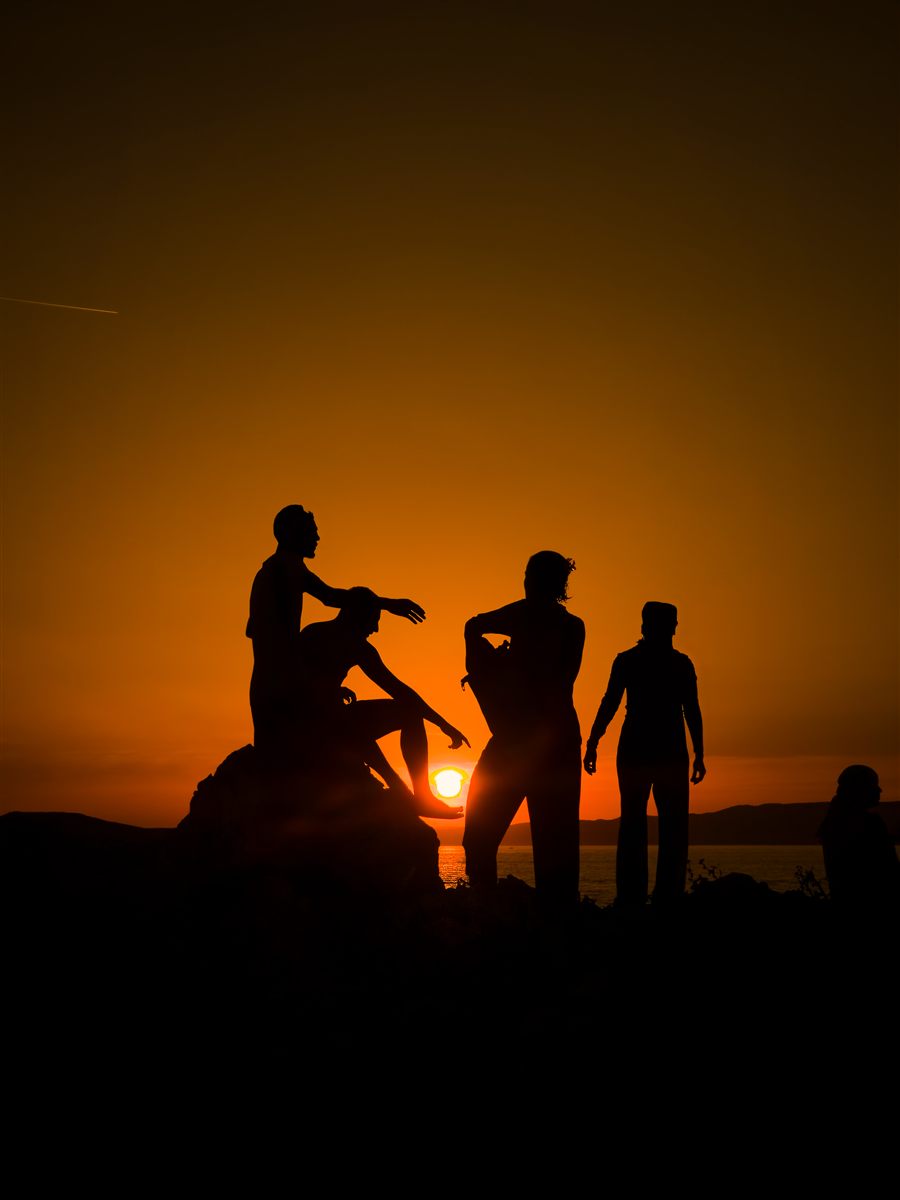 Friends in silhouette at sunset