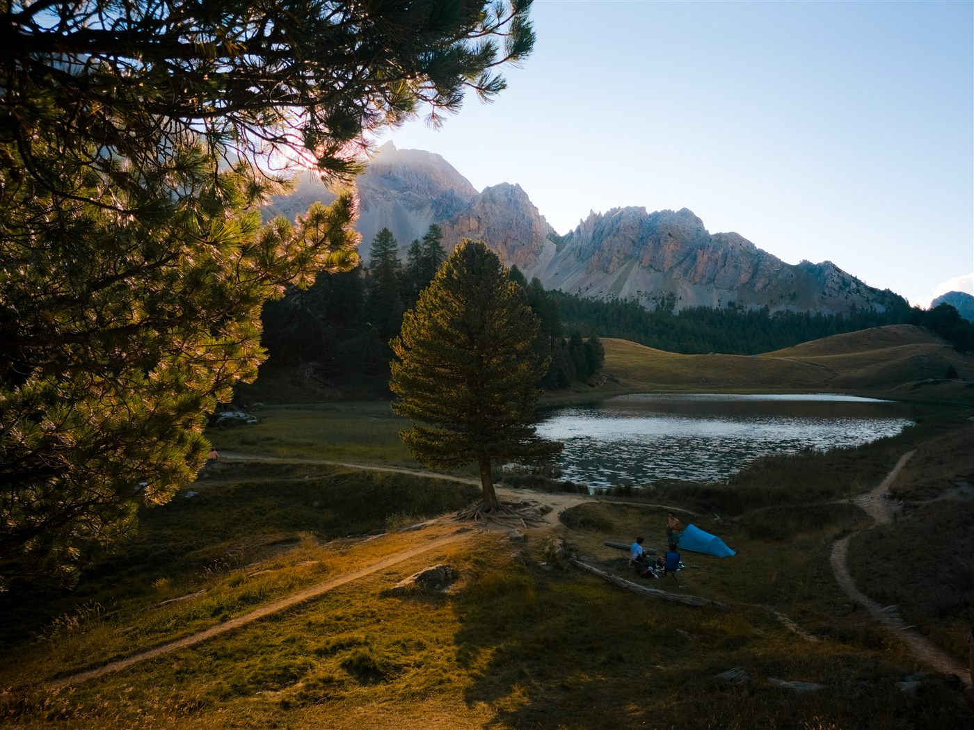 Mountain lake below rocky peaks